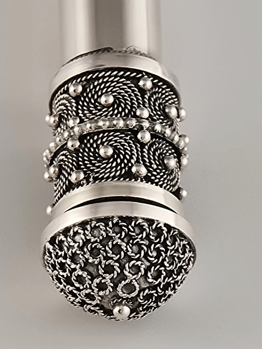 Hulda Mezuzah. This mezuzah was designed in 1990. It is made of sterling silver and measures 6" in length and ¾" in diameter.