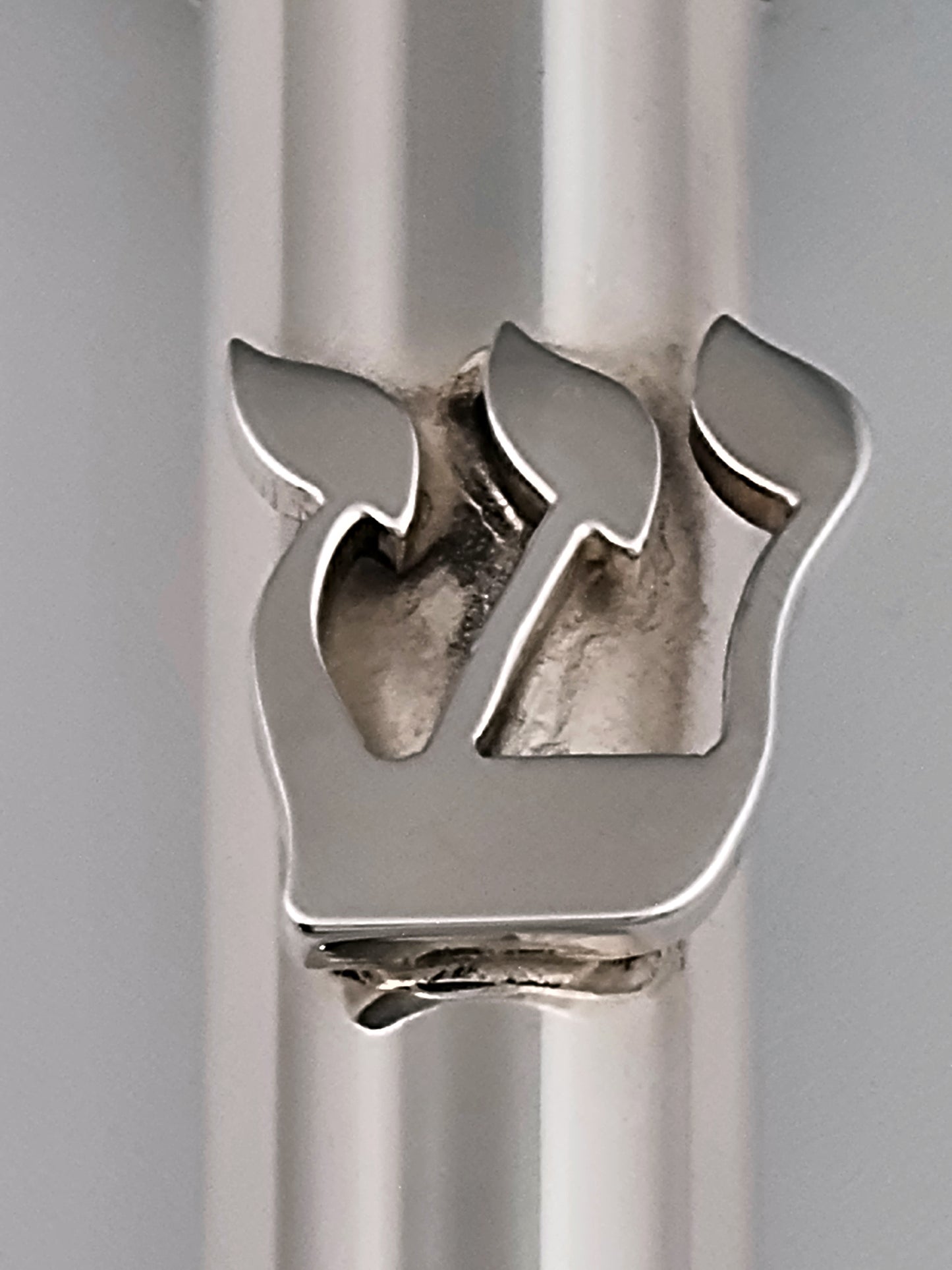 Close-up on the Hebrew letter Shin.