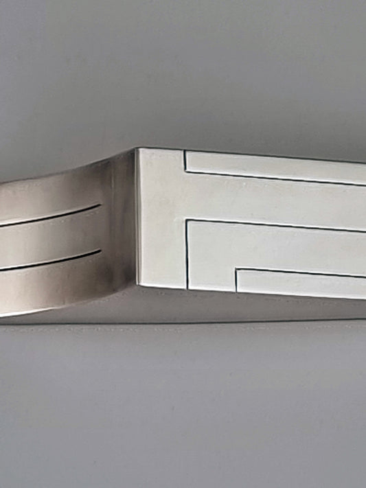 Joshua Mezuzah. This mezuzah was designed in 1986. It is made of sterling silver and measures 5½" long and 1½" wide.