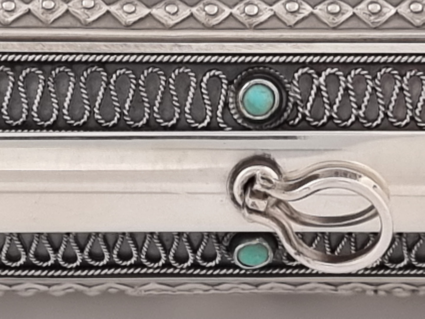 Turquoise and filigree serpent decoration.