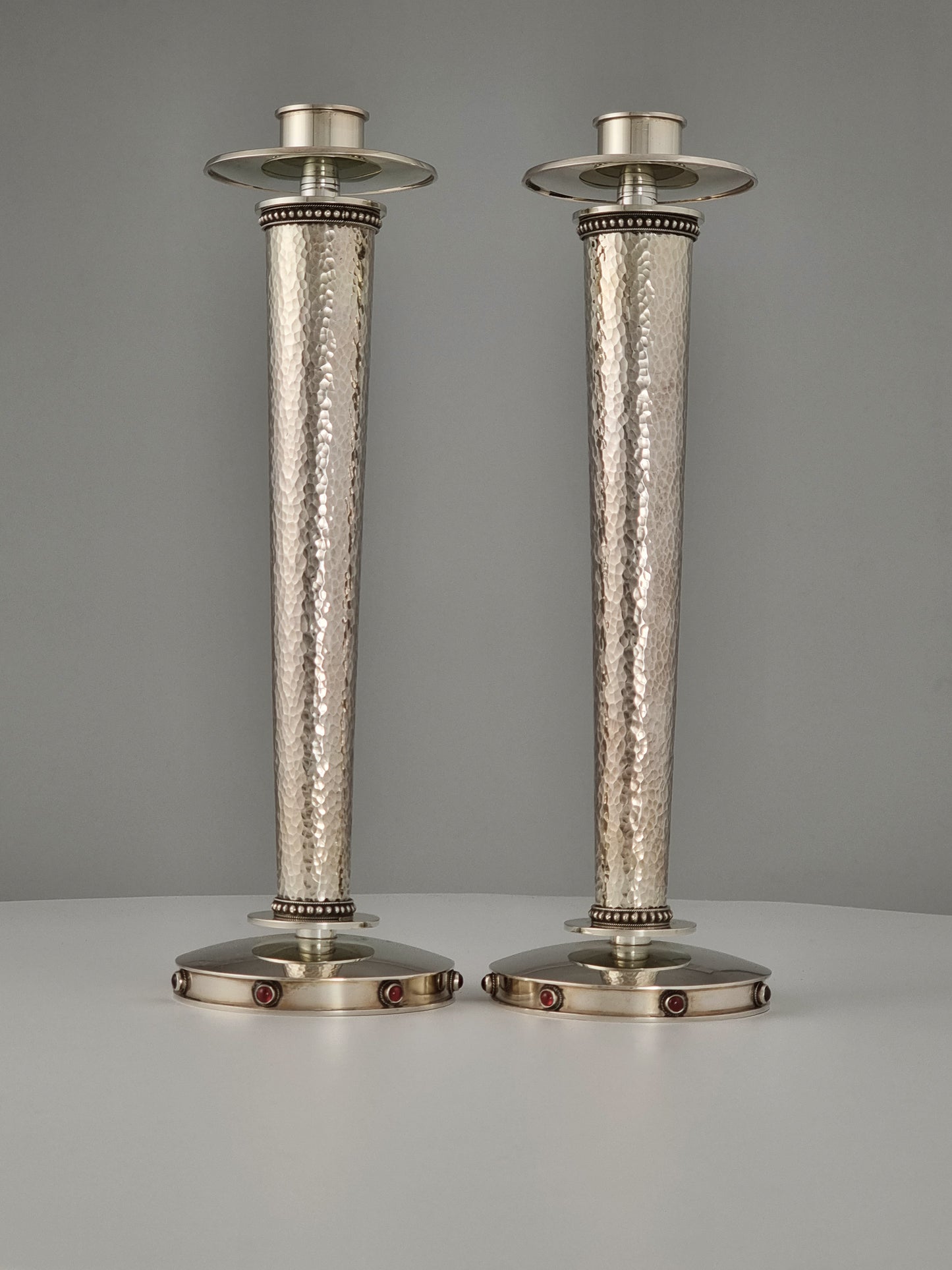 Sarah Candlesticks. These candlesticks were designed in 1999 in sterling silver and garnet stones. They are 10” high.