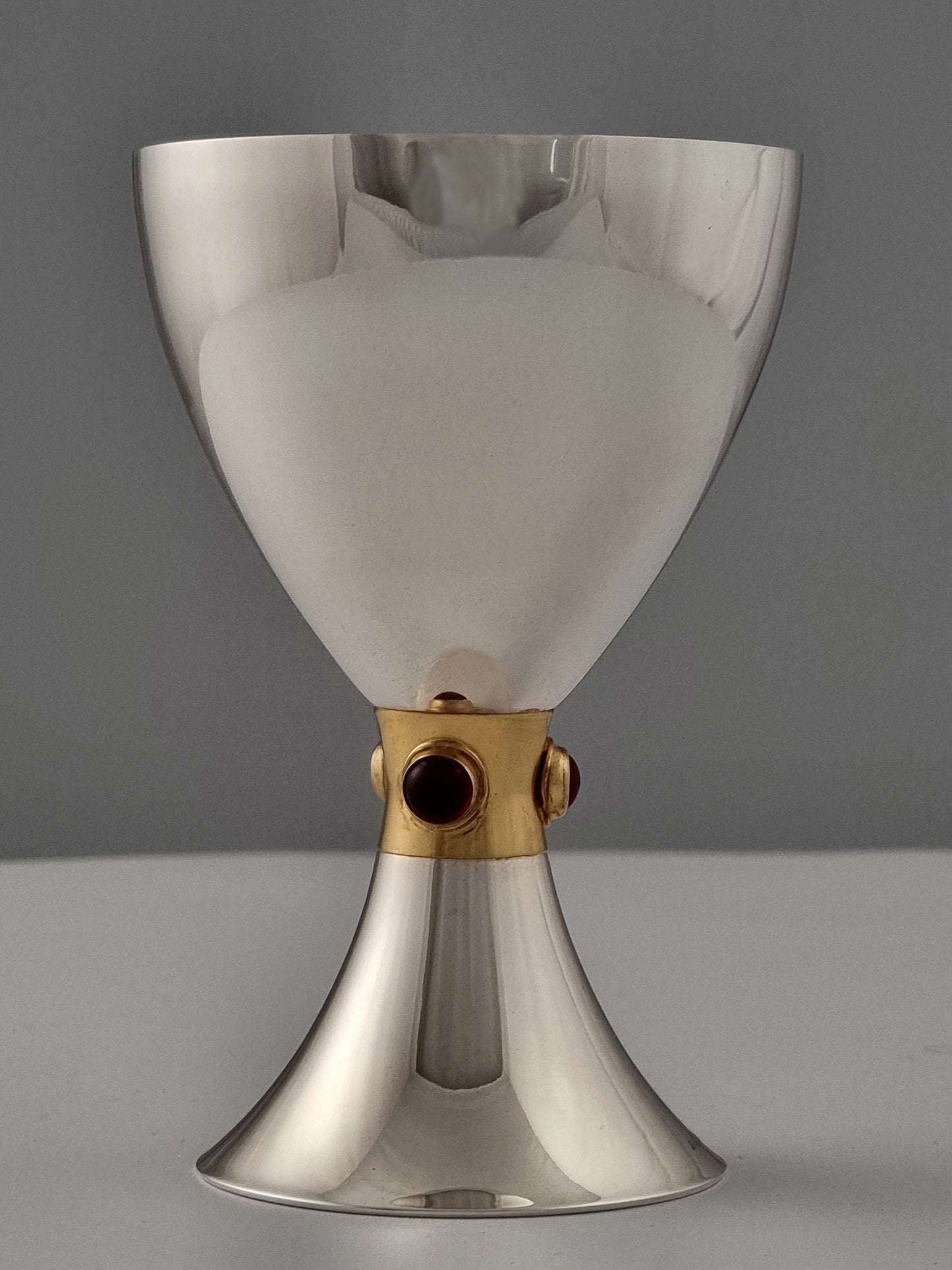 Smooth sterling silver Kiddush cup with a golden ribbon and garnets
