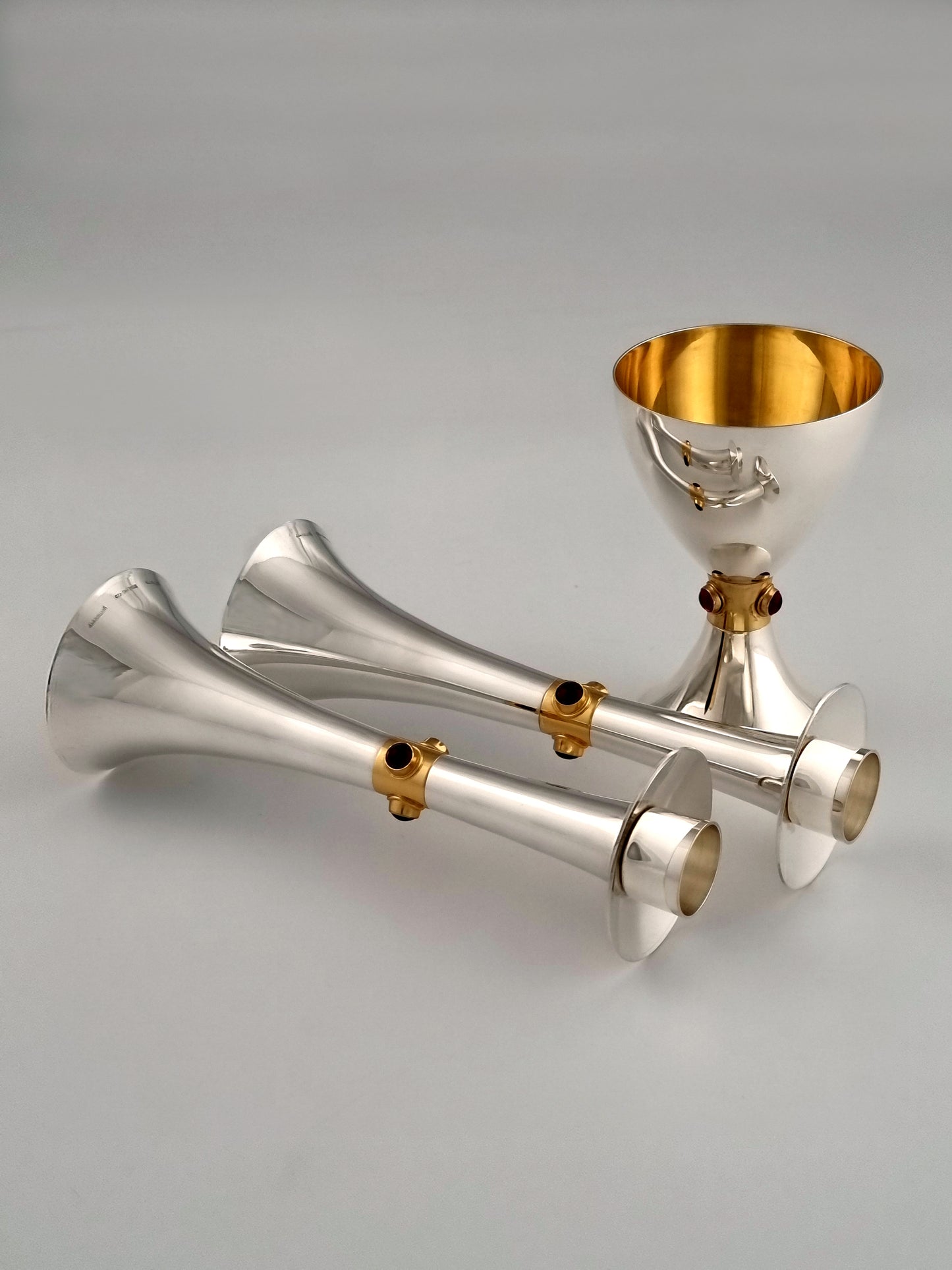 Horizontal Deborah candlesticks reflecting in the matching Kiddush cup