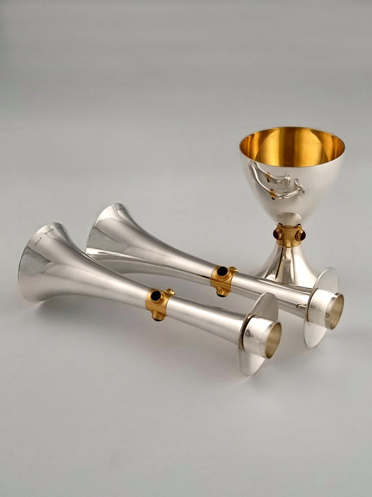 Horizontal Deborah candlesticks reflecting in the matching Kiddush cup