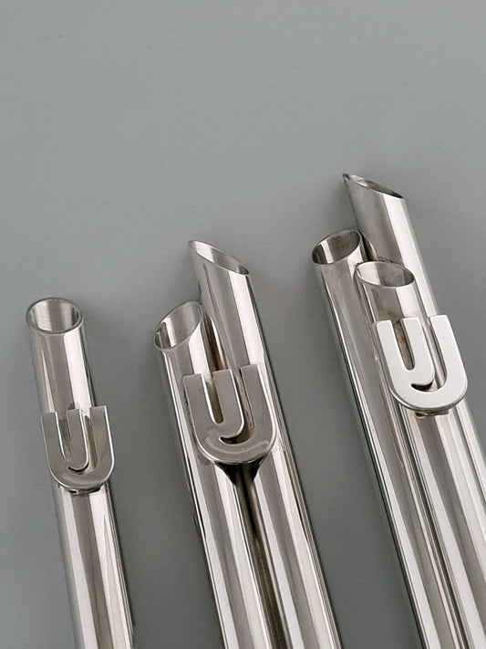 Nahum Mezuzah. These mezuzahs were designed in 1980 and are made of sterling silver. They measure in height: single 6½”, double 7” and triple 8½”.