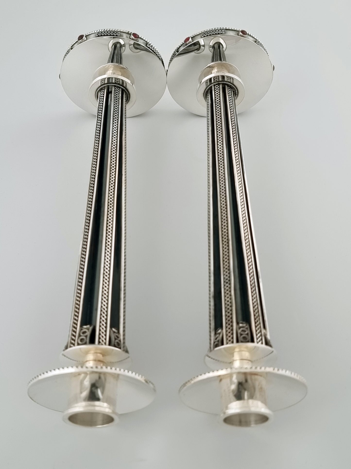 Horizontal view of handmade silver candlesticks.