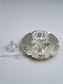 Abigail Honey Dish. This dish was designed in 1994 and is made of sterling silver, measuring 8” in diameter.