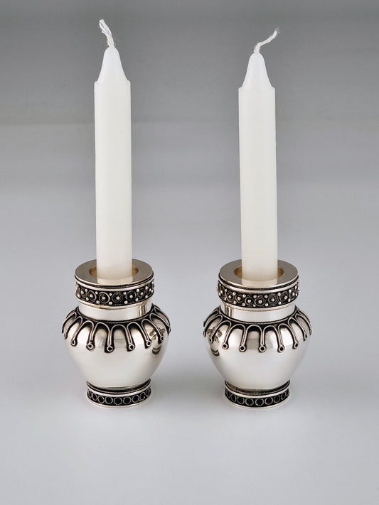Elijah Candlesticks. These candlesticks were designed by Margie in 2003, they measure 2½” in height and are made from sterling silver.