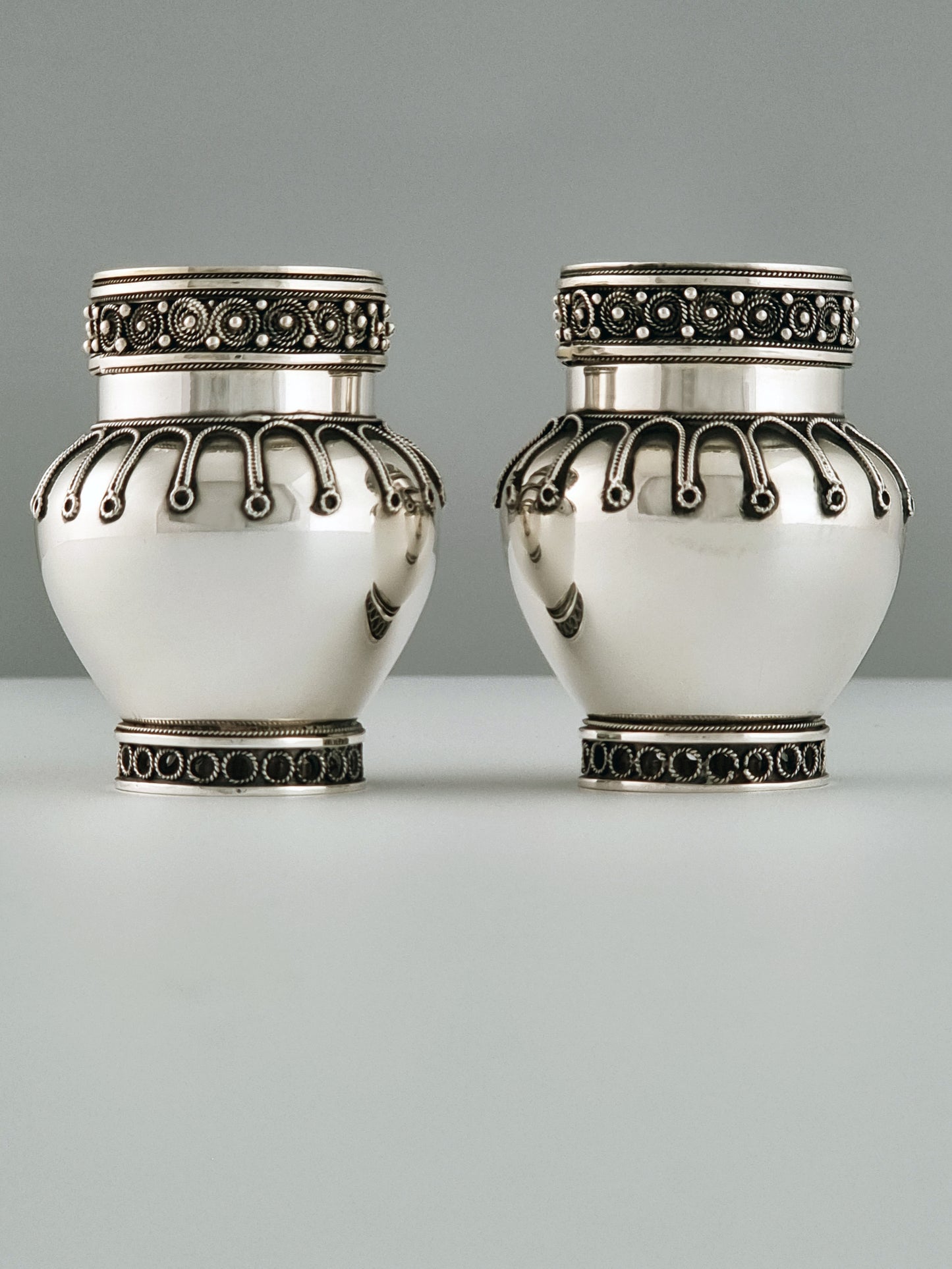 A pair of Yaacov Yemini's candlesticks smiling at each other.