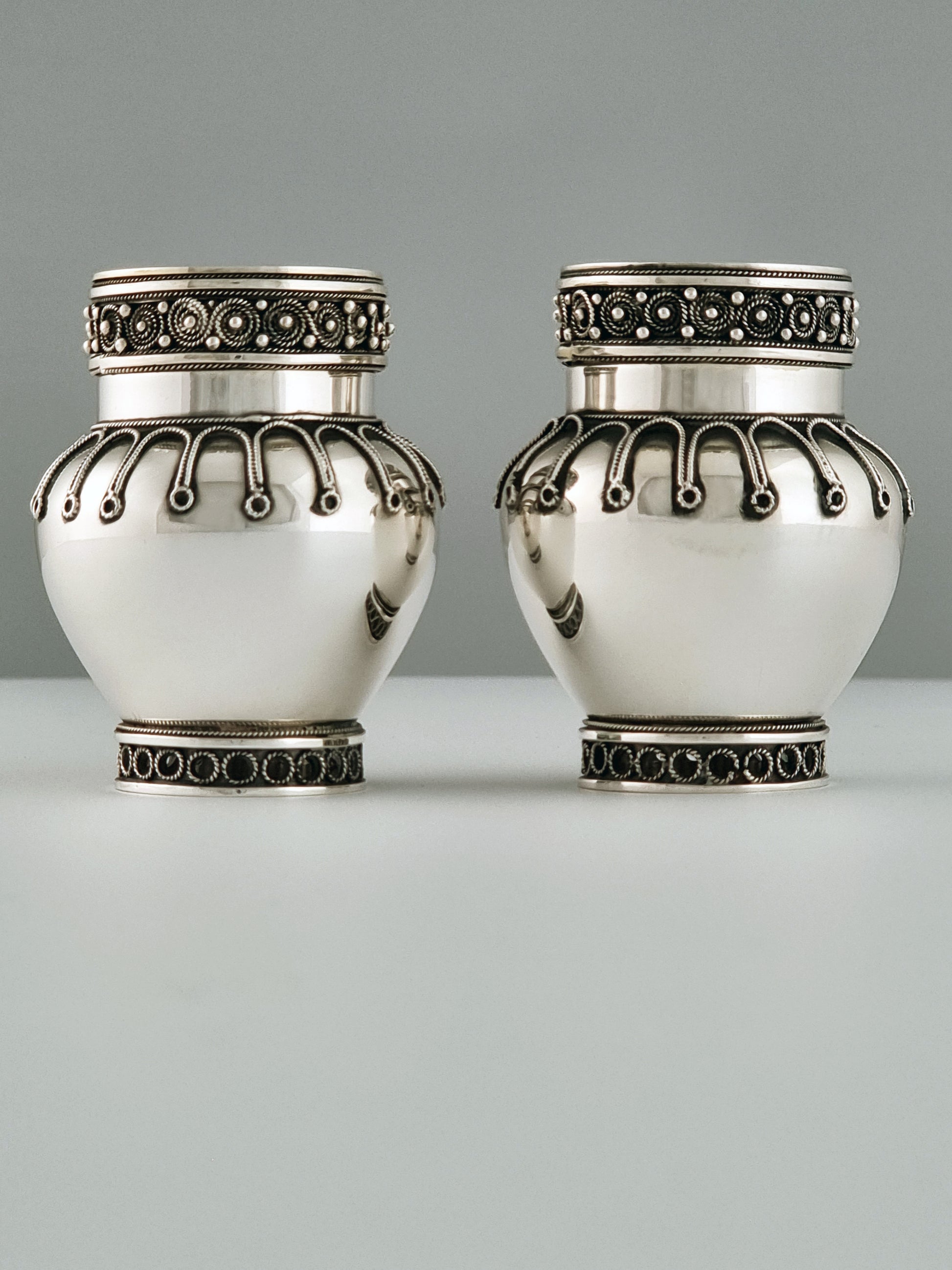 A pair of Yaacov Yemini's candlesticks smiling at each other.