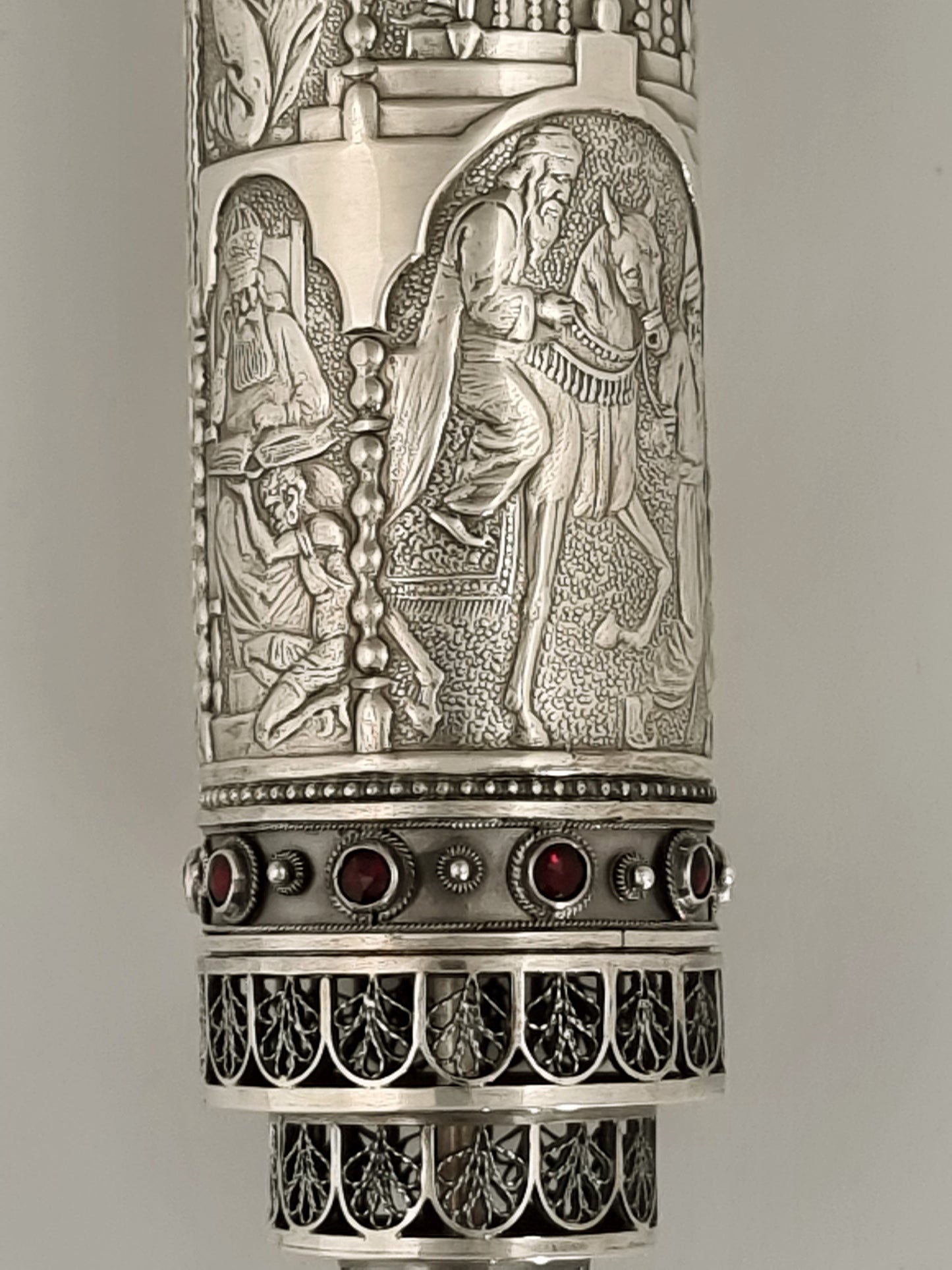Esther Scroll. This piece was designed in 1928. It is made of sterling silver and ornamented with filigree work and garnets. It is 9” high.