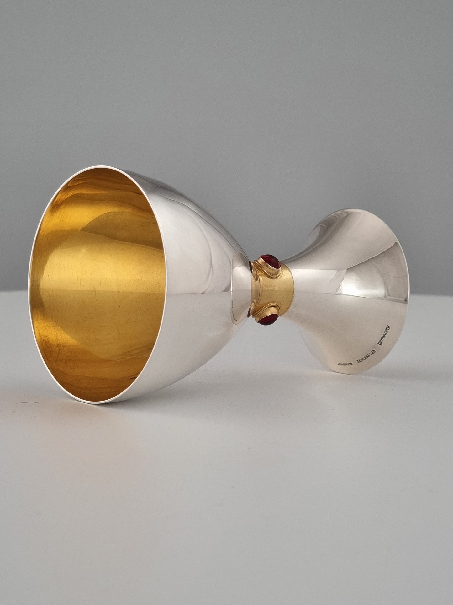 Horizontal Deborah Kiddush cup. Light evenly shines upon the outer silver surfaces.