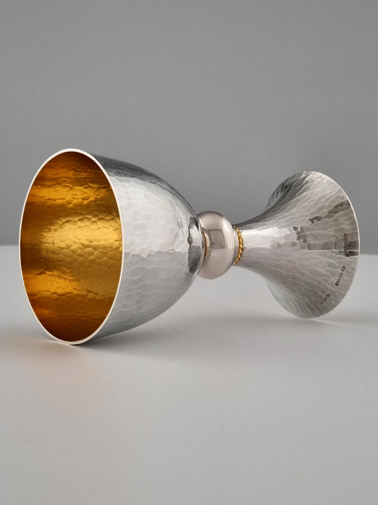 Jeremiah Kiddush Cup. This cup was designed in 1993. It is made of sterling silver and is gold-plated on the inside. It measures 5" high.