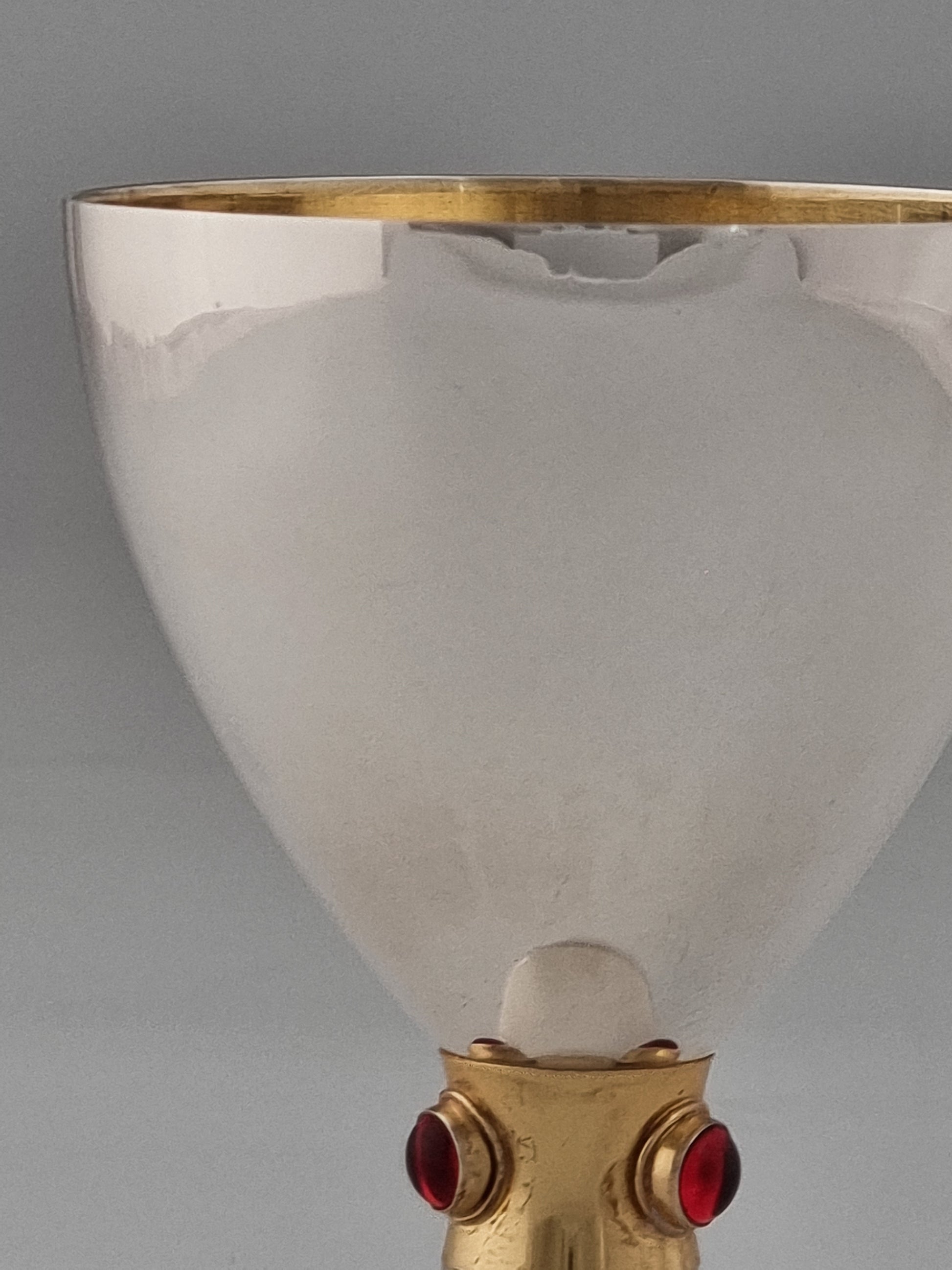 Close-up of Deborah Kiddush cup made in Jerusalem by Yemini silversmiths. A golden ribbon in the center bears three garnet stones