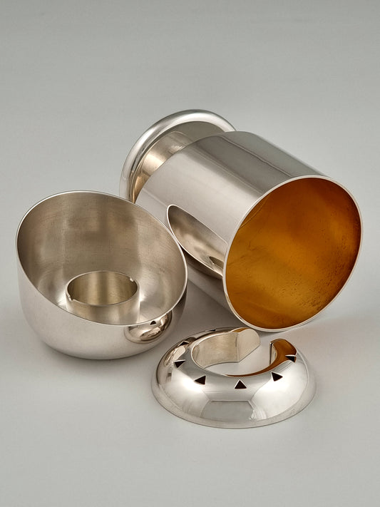 Hannah Havdalah Set. This set was designed in 1989 and made of sterling silver and gold-plated silver, measuring 4½” by 3”.