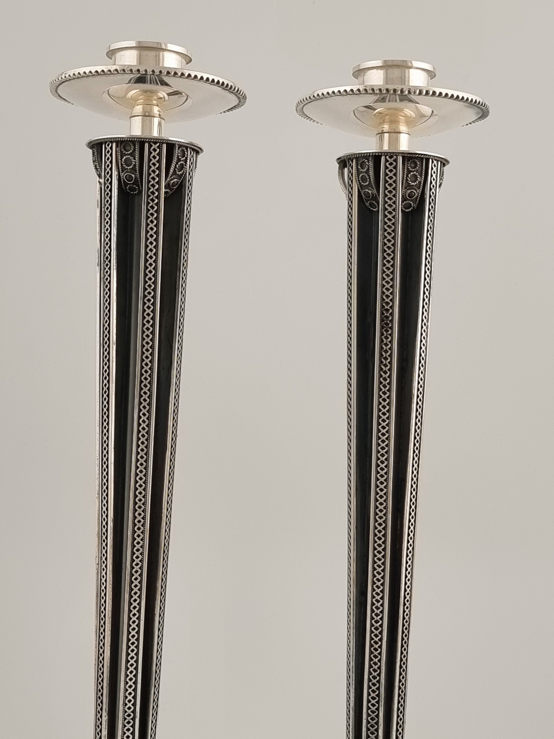 These candlesticks are relatively thin and long, and grow wider towards the top.