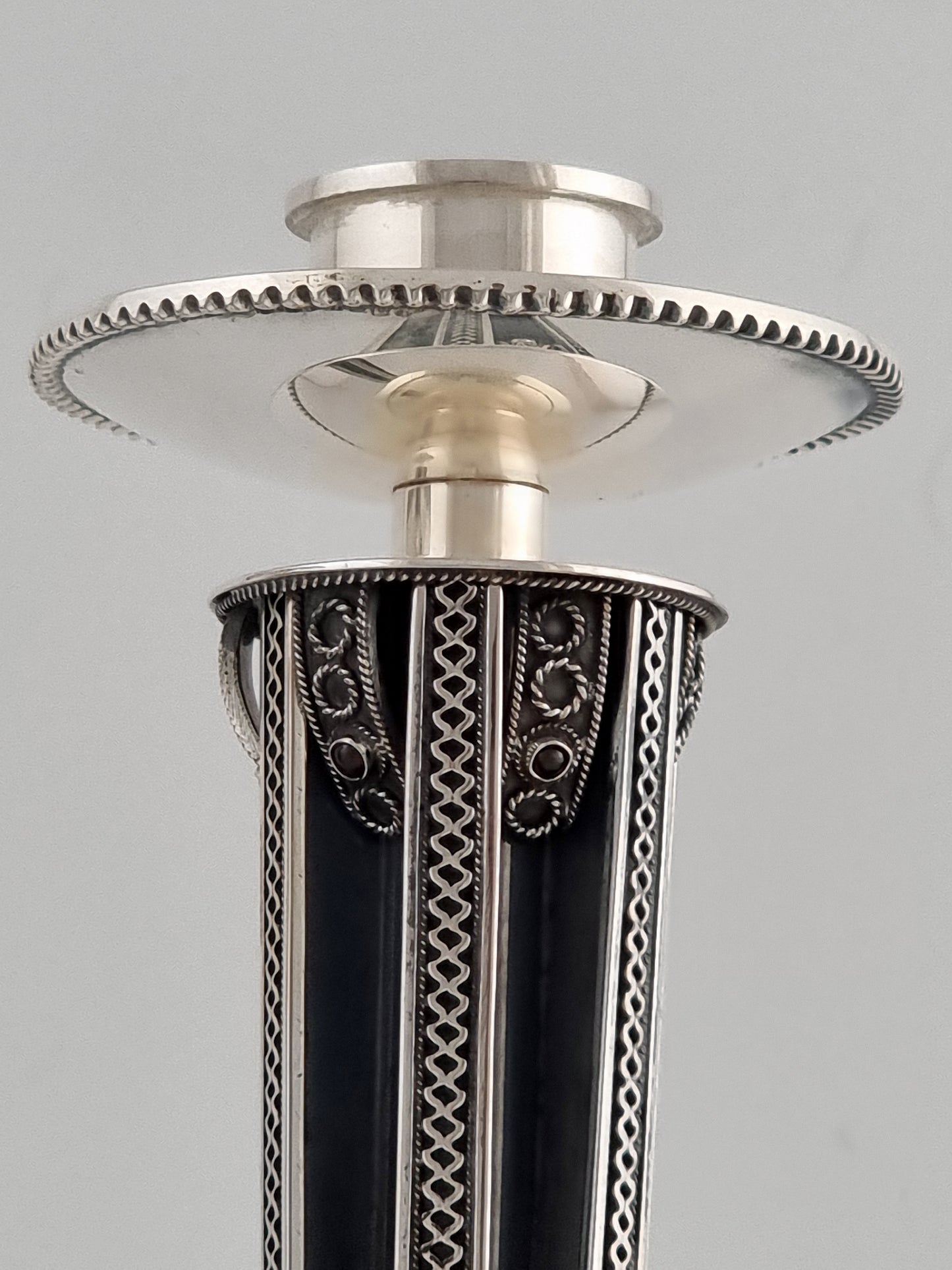 single Yemini candlestick reflecting upon its top.