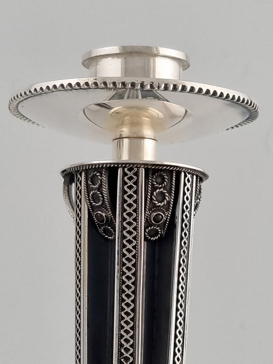 single Yemini candlestick reflecting upon its top.