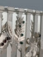 Seven Species Hanukkiah. This exquisite piece was designed in 2000 and measures 13” by 8”. It is made of sterling silver and studded with semi-precious stones.
